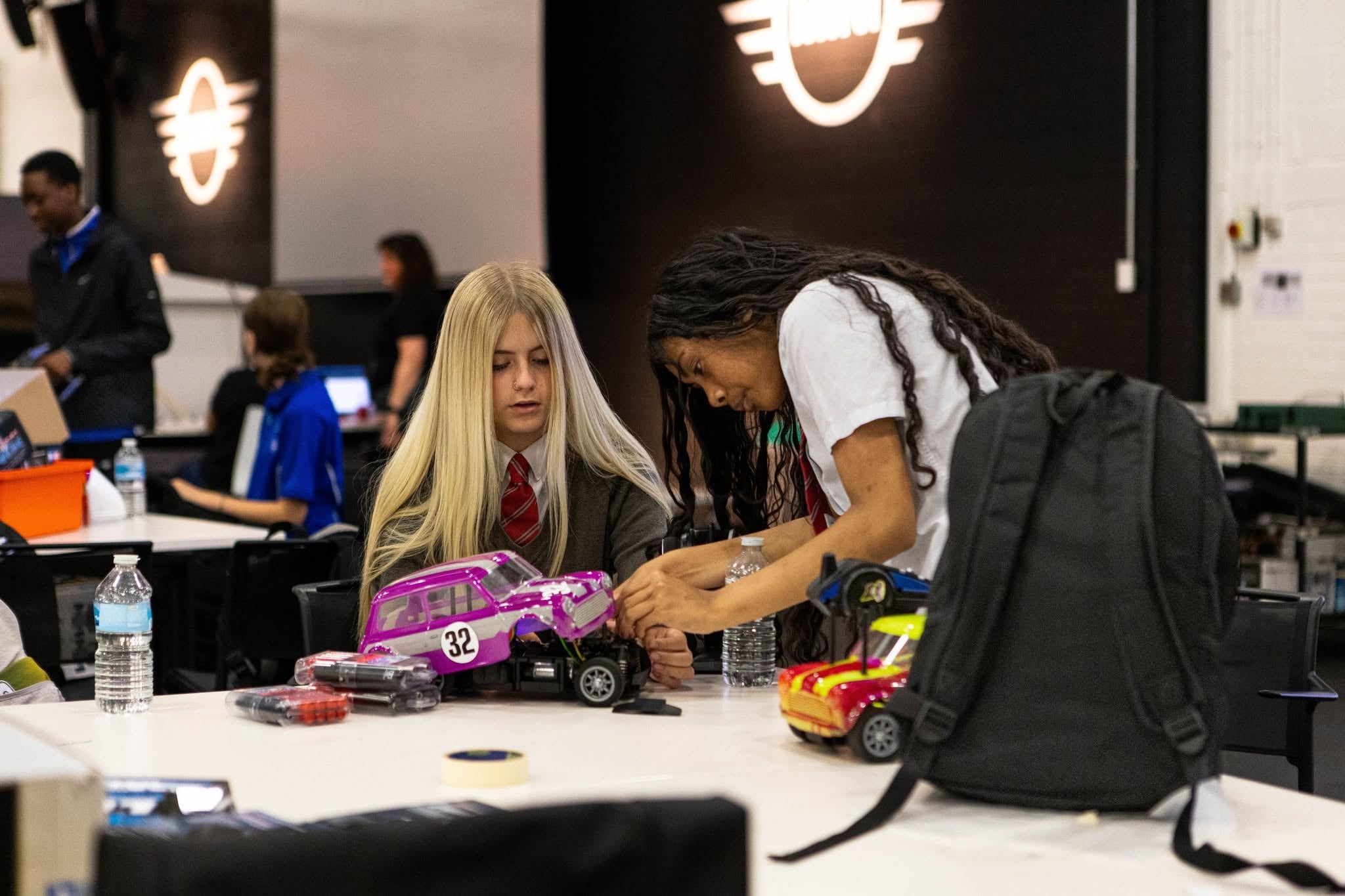 Two RC Vision students building their RC car together at the BMW factory racing event